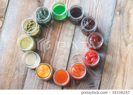 Assortment of sauces in the glass jars Assortment of sauces in the glass jars 38336287