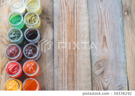 Assortment of sauces in the glass jars 38336292