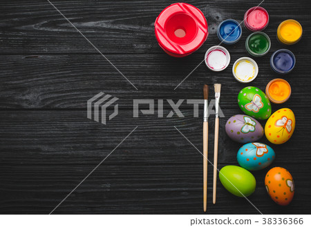 Painting eggs for Easter holiday on wooden table Painting eggs for Easter holiday on wooden table 38336366