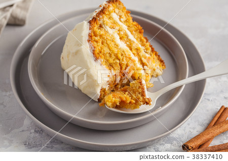 Piece of carrot homemade cake with white cream  38337410