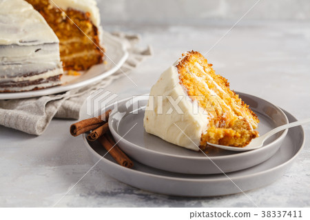 Piece of carrot homemade cake with white cream  38337411