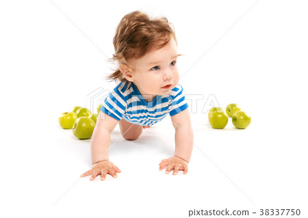 little boy on the floor with green apples little boy on the floor with green apples 38337750