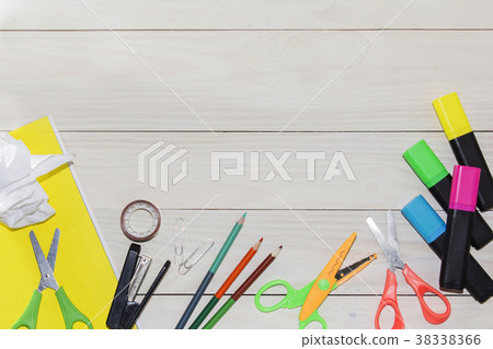 scissors, pencils, pastel pencils on a white table 38338366