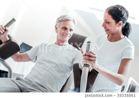 Happy trainer and a smiling old man training Happy trainer and a smiling old man training 38338861