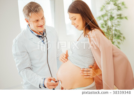 Joyful pregnant woman having a survey and looking 38339348
