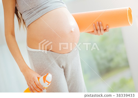 Young pregnant woman standing and preparing for 38339433