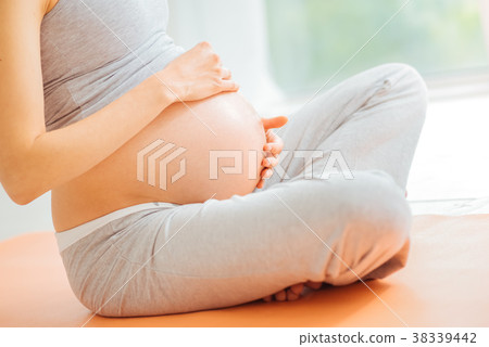 Careful impregnate woman touching to her stomach Careful impregnate woman touching to her stomach 38339442