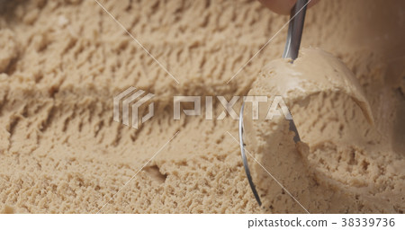 closeup hazelnut praline ice cream scooping with 38339736