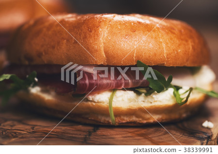 two bagels with prosciutto and cream cheese on 38339991