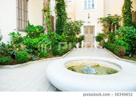Patio with greenery, flowers and fountain 38340652