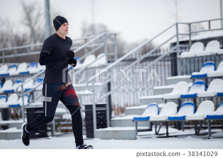 Image of running athlete in black clothes at Image of running athlete in black clothes at 38341029