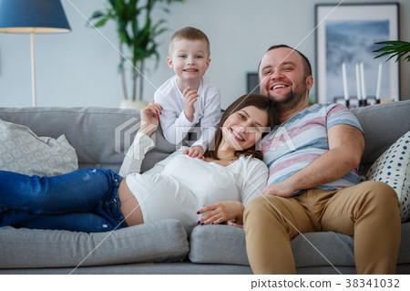 Picture of happy parents with small son on sofa 38341032