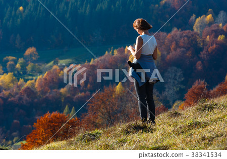 Woman tourist in autumn Carpathian mountain Woman tourist in autumn Carpathian mountain 38341534
