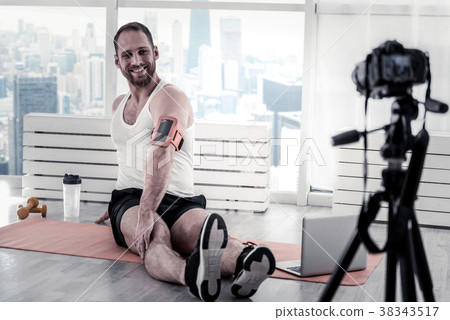 Concentrated male blogger stretching back Concentrated male blogger stretching back 38343517