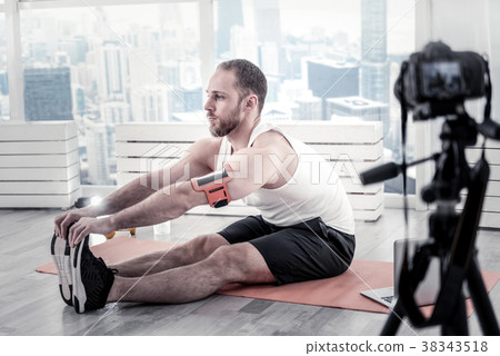 Cheerful male blogger scratching to toes Cheerful male blogger scratching to toes 38343518