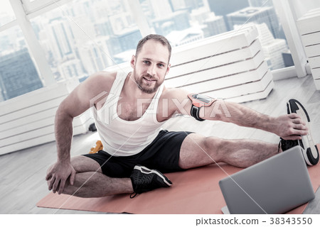 Glad handsome sportsman taking exercises Glad handsome sportsman taking exercises 38343550