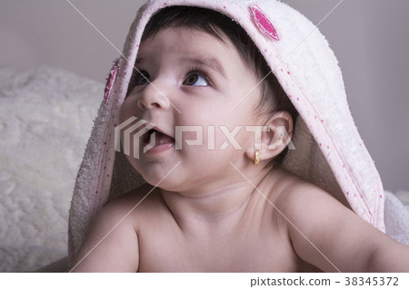 Little baby wearing white bath towel, relaxing  38345372