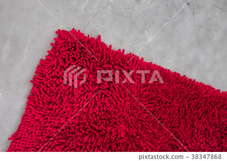 Gray concrete floor with red rug fluffy carpet 38347868