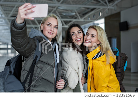 Glad friends making snapshot in the terminal 38351569