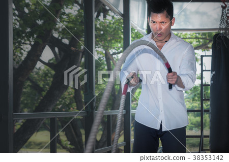 Businessman and battle rope workout for corporate 38353142
