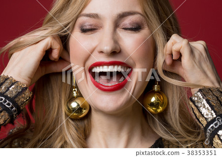 Optimistic girl wearing christmas tree decorations Optimistic girl wearing christmas tree decorations 38353351