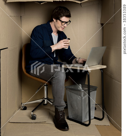 Positive employee is laboring on electronic device 38353389