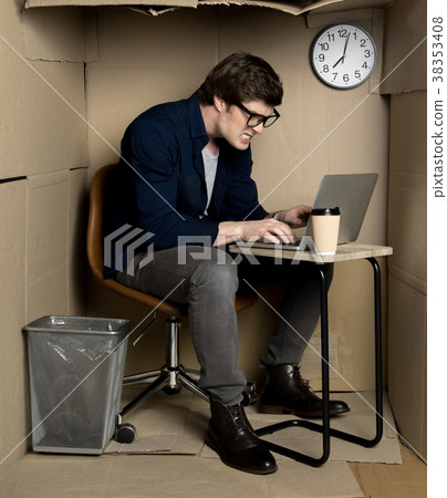 Irritated manager is laboring in confined carton 38353408