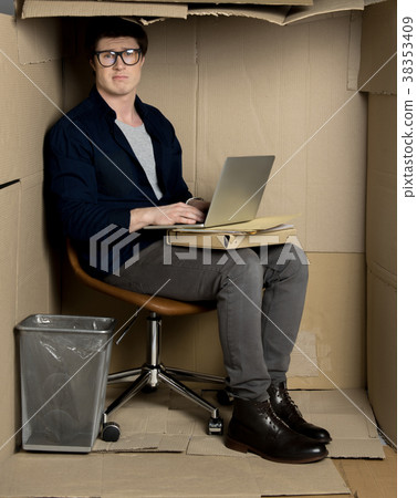 Young employee is working in small workspace 38353409