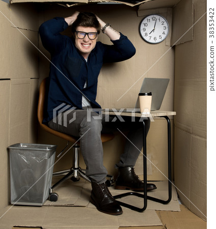 Young employee is feeling rage inside small paper 38353422