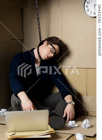 Businessman is killing himself in small cardboard 38353440