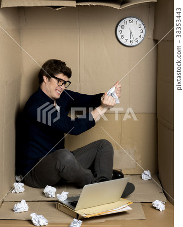Angry worker is tearing paper inside small 38353443