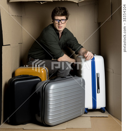 Guy is posing in cramped carton room with his 38354104
