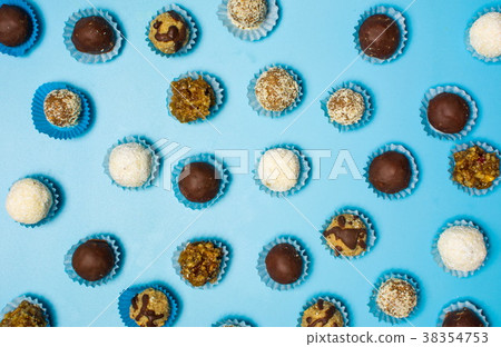 Homemade cookies in paper cups on blue background Homemade cookies in paper cups on blue background 38354753