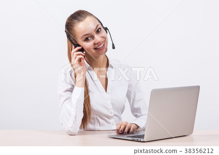 girl in a white blouse with a headset on his head girl in a white blouse with a headset on his head 38356212