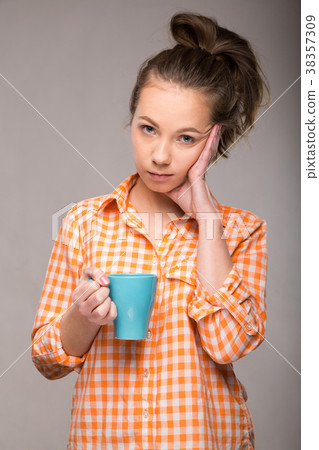 studio portrait of a sleepy woman in an orange studio portrait of a sleepy woman in an orange 38357309