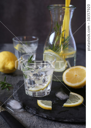 Detox water, lemonade with ice, lemon and rosemary Detox water, lemonade with ice, lemon and rosemary 38357920