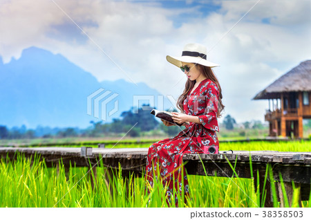 Young woman reading a book  38358503