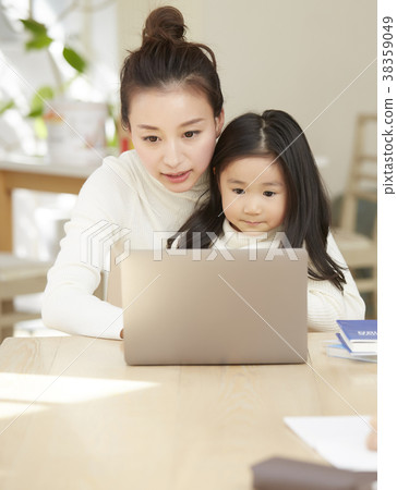 Child playing with mother working in living room 38359049