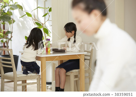 Child playing with mother working in living room 38359051