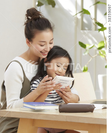 Child playing with mother working in living room Child playing with mother working in living room 38359097