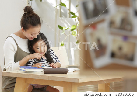Child playing with mother working in living room Child playing with mother working in living room 38359100