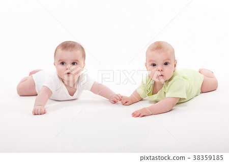 babies girl and boy lying on a white background 38359185