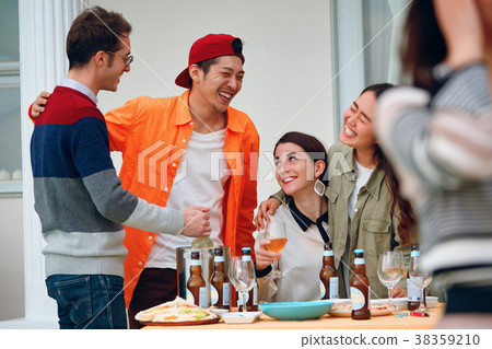 Men and women sharing house image enjoying a party 38359210