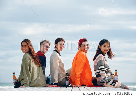 Men and women enjoying parties at the seaside 38359292