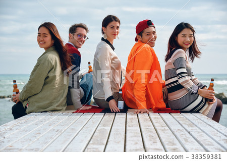 Men and women enjoying parties at the seaside 38359381