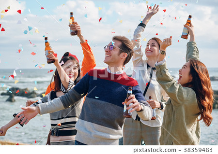 Men and women enjoying parties at the seaside 38359483