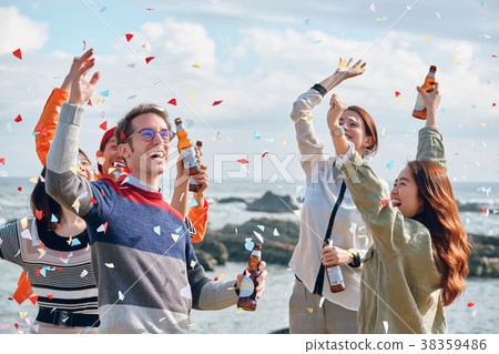 Men and women enjoying parties at the seaside 38359486