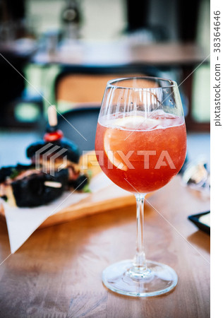 Refreshing red citrus cocktail punch with lemon 38364646
