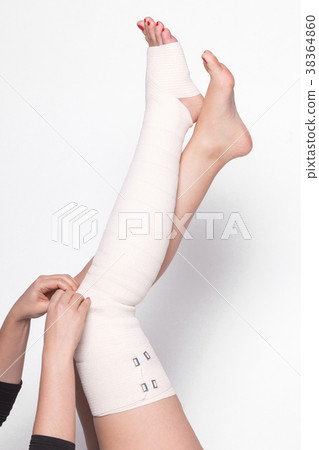 girl on a white background corrects an elastic girl on a white background corrects an elastic 38364860