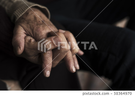 young man holding the hand of an old woman 38364970